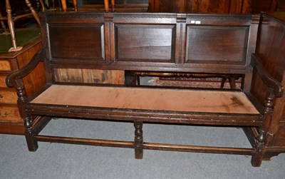 Lot 1501 - Joined oak settle with fielded back support above a later seat, 183cm wide