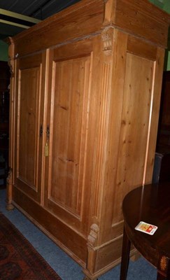 Lot 1522 - ~ A late 19th century pine wardrobe of breakfront form, with two cupboard doors enclosing...