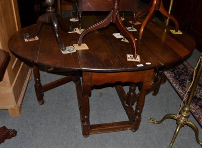 Lot 1525 - An 18th century oak drop-leaf dining table, 153cm extended