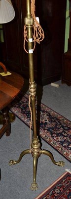 Lot 1526 - Late Victorian brass adjustable standard lamp, with four paw feet