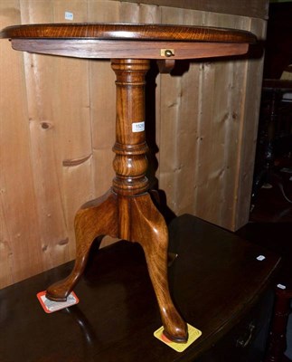 Lot 1529 - A reproduction oak tilt top tripod table.