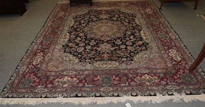 Lot 1542 - Indian carpet, the charcoal field of vines enclosed by a medallion framed by spandrels and...