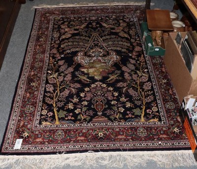 Lot 1545 - An Indian silk on silk rug, the indigo field with lamp beneath the Mihrab enclosed by floral...