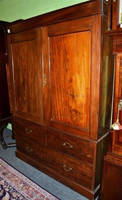 Lot 1572 - ~ A 19th century mahogany linen press, with two cupboard doors enclosing hanging space the base...