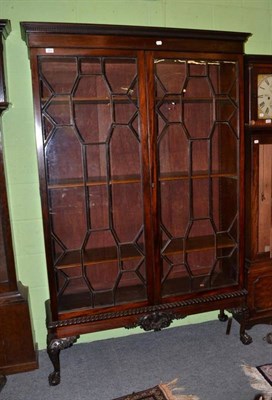 Lot 1574 - A mahogany glazed bookcase on stand