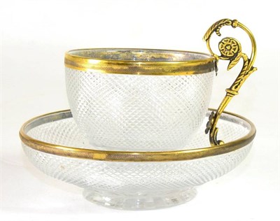 Lot 208 - A French Gilt Metal Mounted Cut Glass Coffee Cup and Saucer, 19th century, the leaf sheathed scroll