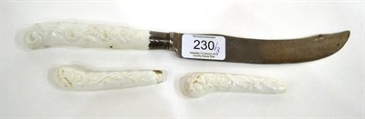 Lot 230 - A Chelsea Porcelain Knife Handle, circa 1755, moulded with scrolls and flowers, the steel blade...