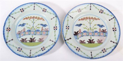 Lot 259 - A Pair of English Delft Plates, probably Lambeth, circa 1780, painted in colours with a fenced...