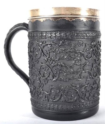 Lot 262 - A White Metal Mounted Wedgwood Black Basalt Large Mug, circa 1800, decorated in relief with...
