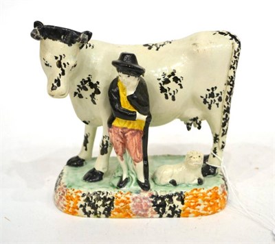 Lot 267 - A Yorkshire Pratt Type Pottery Cow Group, circa 1800, the standing beast with black sponged...