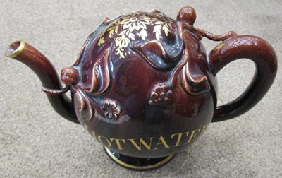 Lot 291 - A Brameld Treacle Glazed Cadogan Teapot, circa 1830, of traditional form, inscribed in gilt HOT...