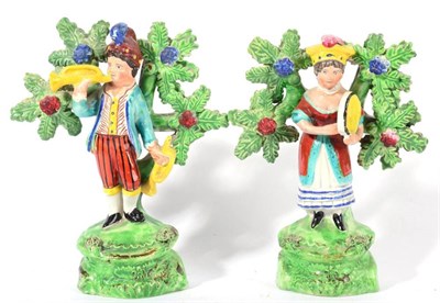 Lot 296 - A Pair of Walton Type Pearlware Figures of Musicians, early 19th century, he holding trumpets,...