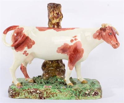 Lot 298 - A Large Staffordshire Pottery Cow Spill Vase, early 19th century, the naturalistically modelled and