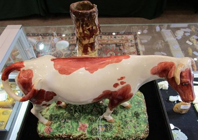 Lot 298 - A Large Staffordshire Pottery Cow Spill Vase, early 19th century, the naturalistically modelled and