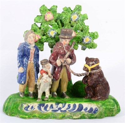 Lot 299 - A Staffordshire Pearlware Bear Bating Group, circa 1820, as two gentlemen and a boy with a bear and