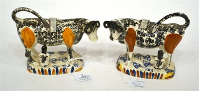 Lot 301 - A Matched Pair of Pearlware Cow Creamers, circa 1820, with black and ochre sponged markings,...
