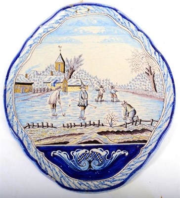 Lot 345 - A Dutch Delft Wall Plaque, 19th century, of shaped oval form, painted in colours with figures...