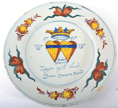 Lot 357 - A Presentation Delft Charger, dated 1767, painted in colours with a crowned pair of hearts...