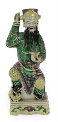 Lot 369 - A Chinese Bisque Porcelain Figure of an Immortal, Kangxi, the seated figure wearing a...
