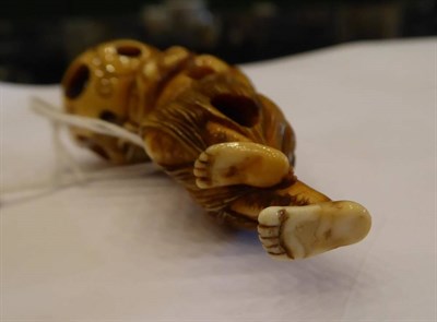 Lot 408 - A Japanese Ivory Netsuke, Edo period, carved as a South Sea islander wearing a grass skirt...