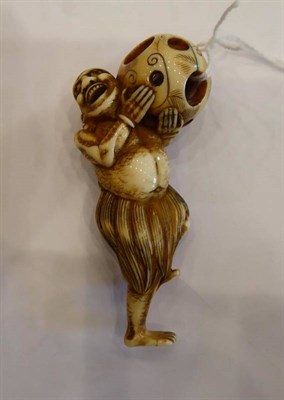 Lot 408 - A Japanese Ivory Netsuke, Edo period, carved as a South Sea islander wearing a grass skirt...