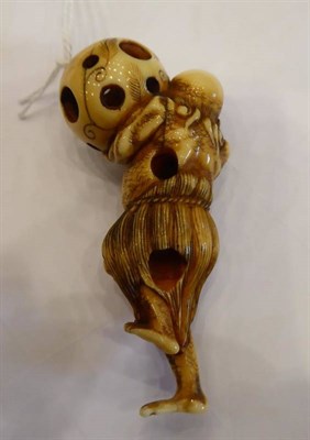 Lot 408 - A Japanese Ivory Netsuke, Edo period, carved as a South Sea islander wearing a grass skirt...