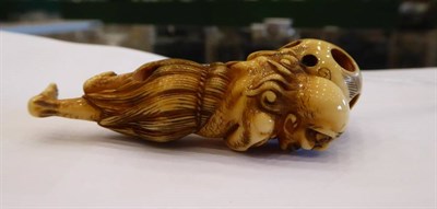 Lot 408 - A Japanese Ivory Netsuke, Edo period, carved as a South Sea islander wearing a grass skirt...