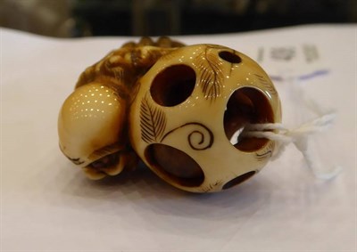 Lot 408 - A Japanese Ivory Netsuke, Edo period, carved as a South Sea islander wearing a grass skirt...