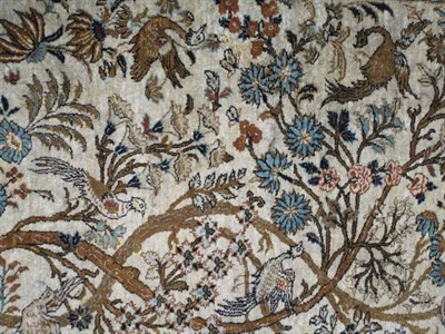 Lot 1185 - Ghom Silk Rug Central Iran, circa 1960 The ivory field with trees, birds and animals enclosed...