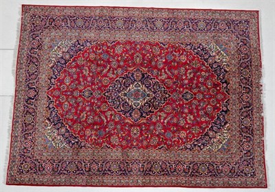 Lot 1190 - Kashan Carpet  Central Iran, circa 1960 The raspberry field of palmettes and vines around a...