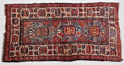 Lot 1195 - Kazak Rug Central Caucasus, late 19th/early 20th century The madder field with three medallions...
