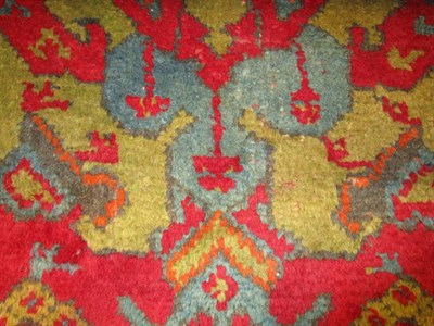 Lot 1199 - Ushak Carpet Central/West Anatolia, circa 1900 The tomato red field with columns of diamond and...