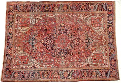Lot 1203 - Heriz Carpet Iranian Azerbaijan, 1920 The blood red field of angular vines centred by an indigo...