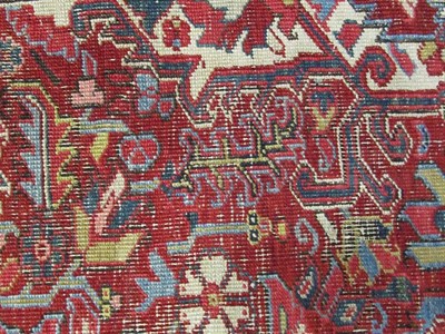 Lot 1203 - Heriz Carpet Iranian Azerbaijan, 1920 The blood red field of angular vines centred by an indigo...