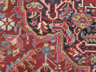 Lot 1203 - Heriz Carpet Iranian Azerbaijan, 1920 The blood red field of angular vines centred by an indigo...