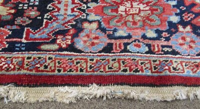 Lot 1203 - Heriz Carpet Iranian Azerbaijan, 1920 The blood red field of angular vines centred by an indigo...