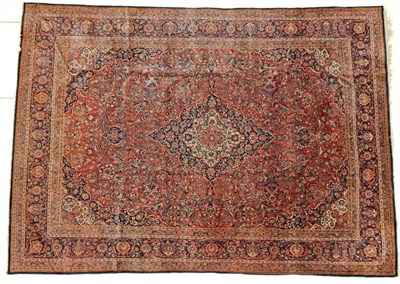Lot 1207 - Kashan Carpet Central Iran, circa 1930 The madder field of vines centred by an indigo and ivory...