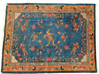 Lot 1208 - Chinese Carpet, circa 1920 The indigo field centred by a phoenix flanked by sprigs and further...