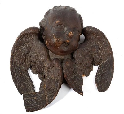 Lot 1090 - A Carved Wood Winged Cherub Mask, 17th century, 42cm wide
