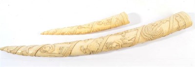Lot 1099 - A Carved Elephant Tusk, circa 1920, carved in traditional style with figures, goats, trees and...