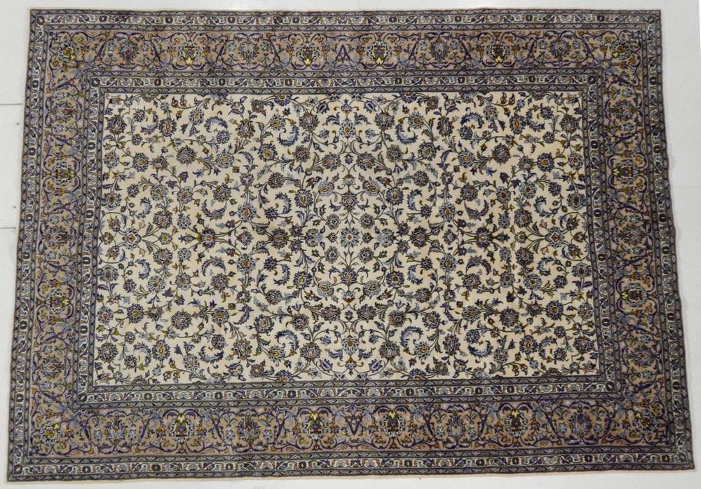 Lot 1174 - Kashan Carpet Central Iran, circa 1960 The ivory field with an all over design of scrolling...