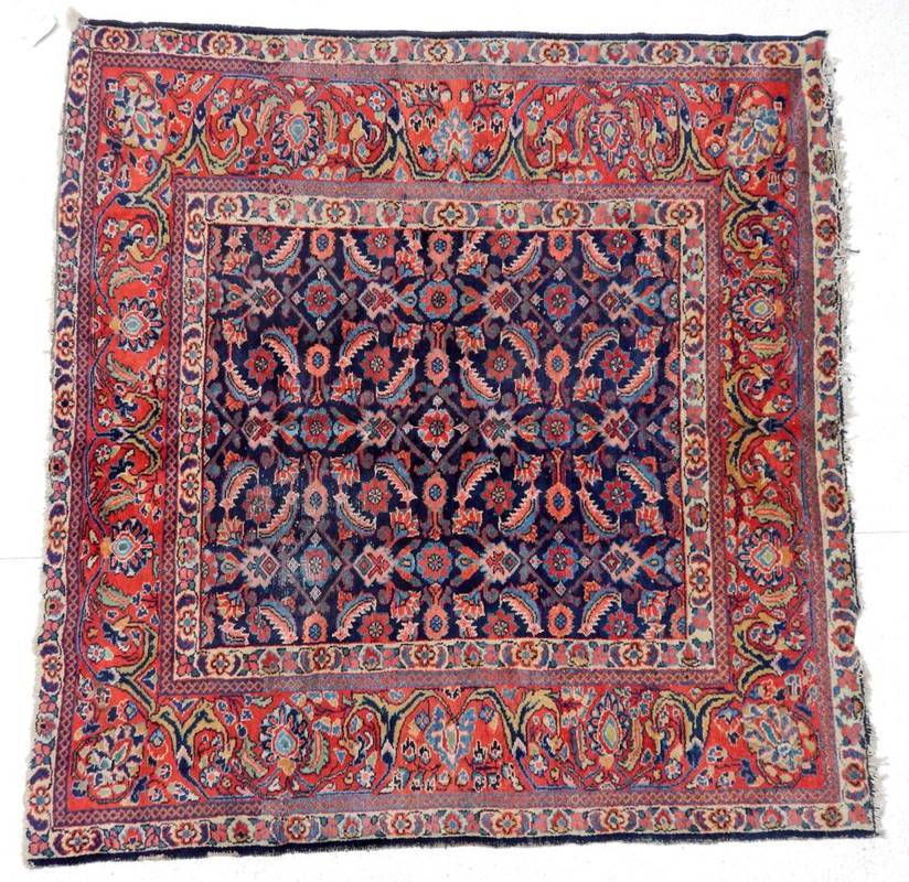 Lot 1176 - Feraghan Rug of unusual size West Iran, 20th century The indigo Herati field enclosed by meandering