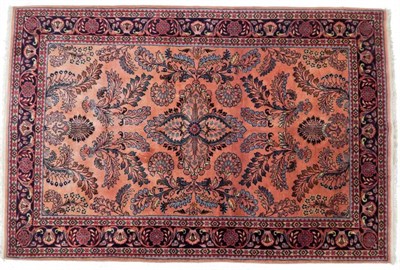 Lot 1231 - Saroukh Rug West Iran, circa 1930 The pale coral field of scrolling leaves enclosed by...
