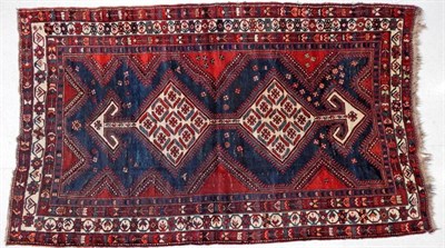 Lot 1235 - Luri Rug West Iran, circa 1925 The indigo field with twin ivory diamond medallions enclosed by...