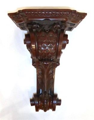 Lot 1257 - A Victorian Mahogany Carved Wall Clock Bracket, late 19th century, scroll and leaf decorated carved