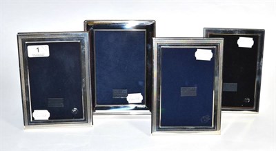 Lot 1 - Four rectangular modern silver photograph frames, including a pair with engraved border, the...