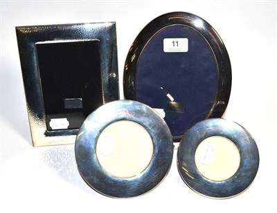 Lot 11 - Four modern silver photograph frames, one oval, two circular and one rectangular example with...