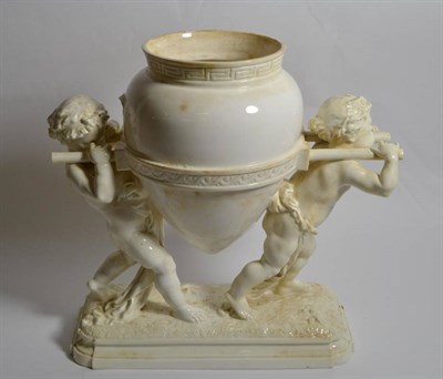 Lot 19 - A Victorian blanc de chine centrepiece, cherubs carrying amphora on integral base, 32cm height