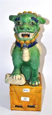 Lot 22 - A Chinese heavily glazed temple lion on an integral plinth, late 19th century, 46cm height