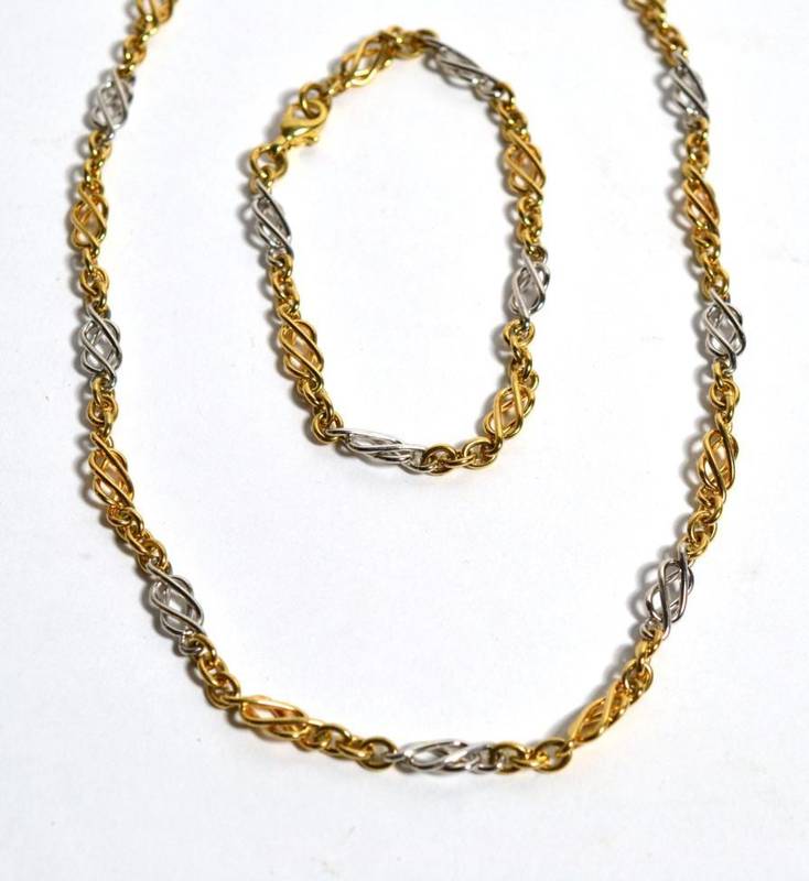Lot 57 - A 9ct two coloured gold Celtic link necklace and bracelet set, 33g gross (2)